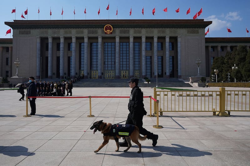2024年3月11日,中国北京,人大会闭幕前,警察携警犬在人民大会堂外巡逻。(美联社)